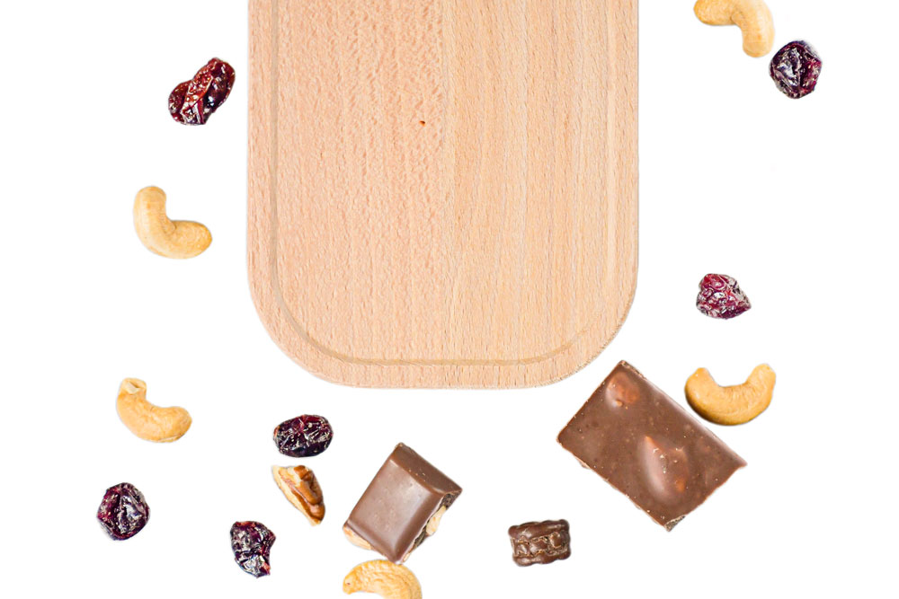 Beech lid for lunch box, decoratively arranged with chocolate, nuts, and dried fruit – sustainable replacement part